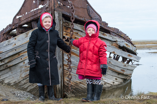 Girls with Moosawa shipwreck on Hudson Bay at Nanuk Polar Bear Lodge.