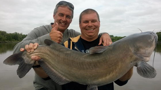 Nolan with 37-inch catfish. Mike with thumbs up.