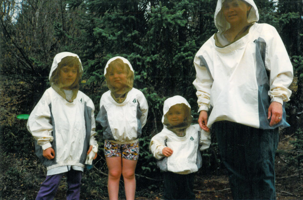 (L-to-R) Rebecca, Karli and Allison Reimer with Mom Jeanne. Bug suits on! Well, sort of.