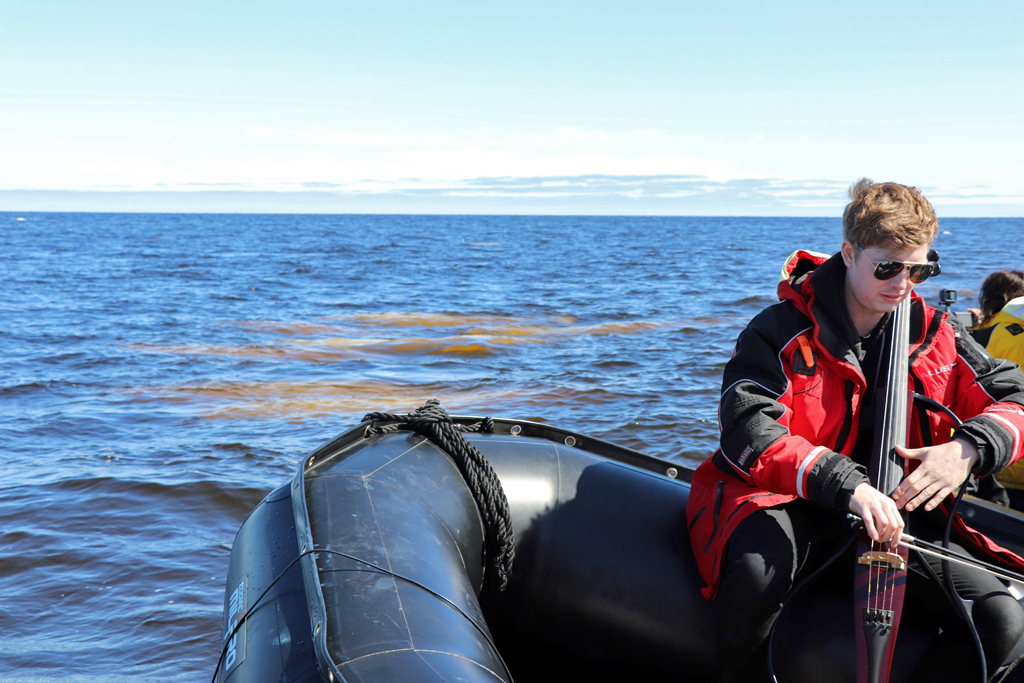 Cellist Rob Knaggs performs with the beluga whales of Hudson Bay near Seal River.