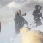Polar bear in snow with guests. Seal River Heritage Lodge. Redeana Villeneuve photo.