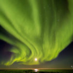 Curtain of northern lights over full moon. Seal River Heritage Lodge. James Heupel photo.