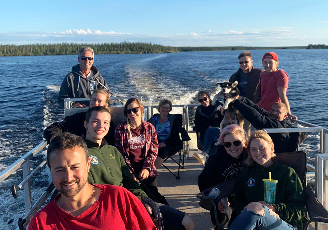 Playing hard! One of the benefits of being isolated in a small group in northern Manitoba. Pontoon boat ride!