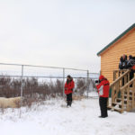 Guests talking to polar bear outside fence at Dymond Lake Ecolodge. Dafna Bennun photo.