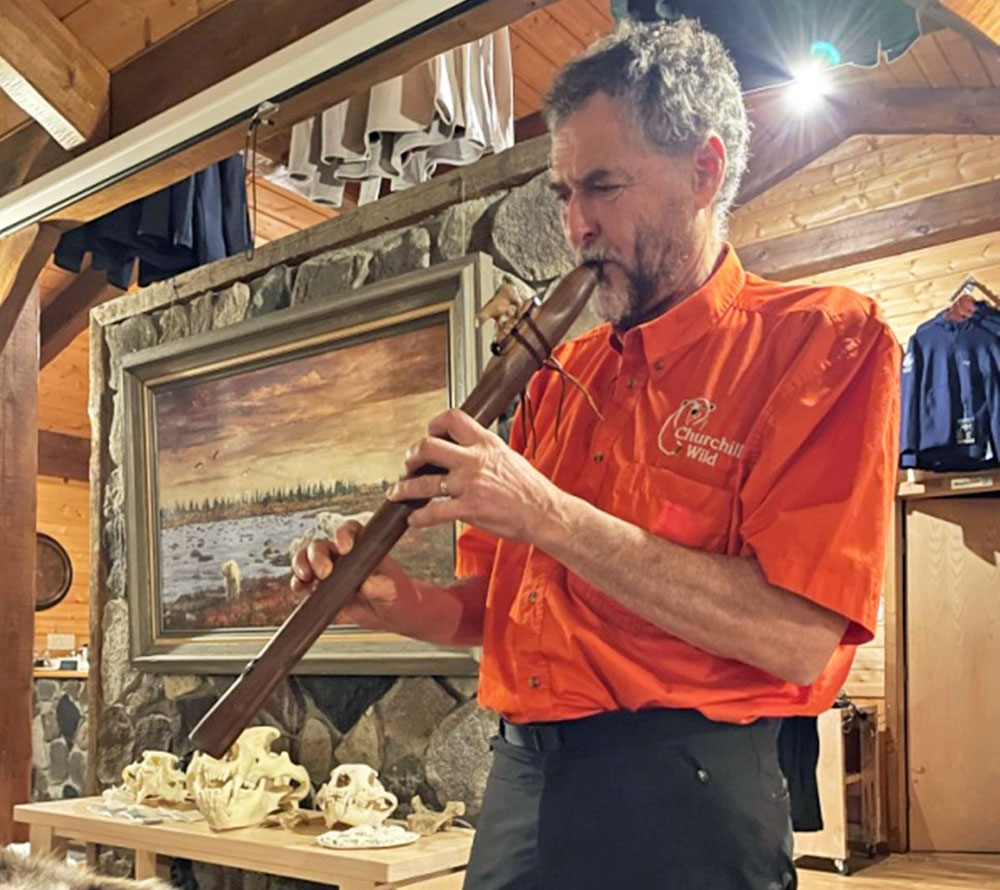 Jean Tanguay plays the polar bear flute for guests at Dymond Lake Ecolodge.