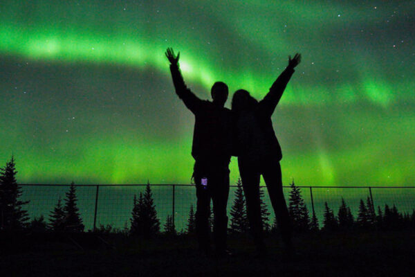 Guests celebrating the northern lights at Nanuk Polar Bear Lodge.