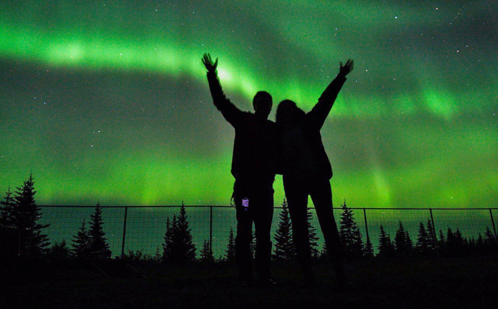 Guests celebrating the northern lights at Nanuk Polar Bear Lodge.