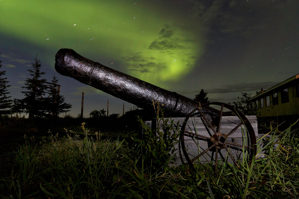 300-year-old cannon under the northern lights at Nanuk Polar Bear Lodge. Charles Glatzer photo.