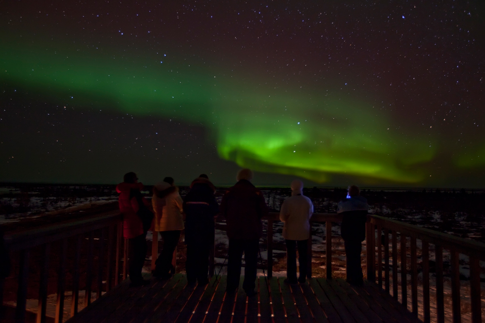 Guests observing northern lights at Seal River Heritage Lodge on the Polar Bear Photo Safari. Robert Postma photo.