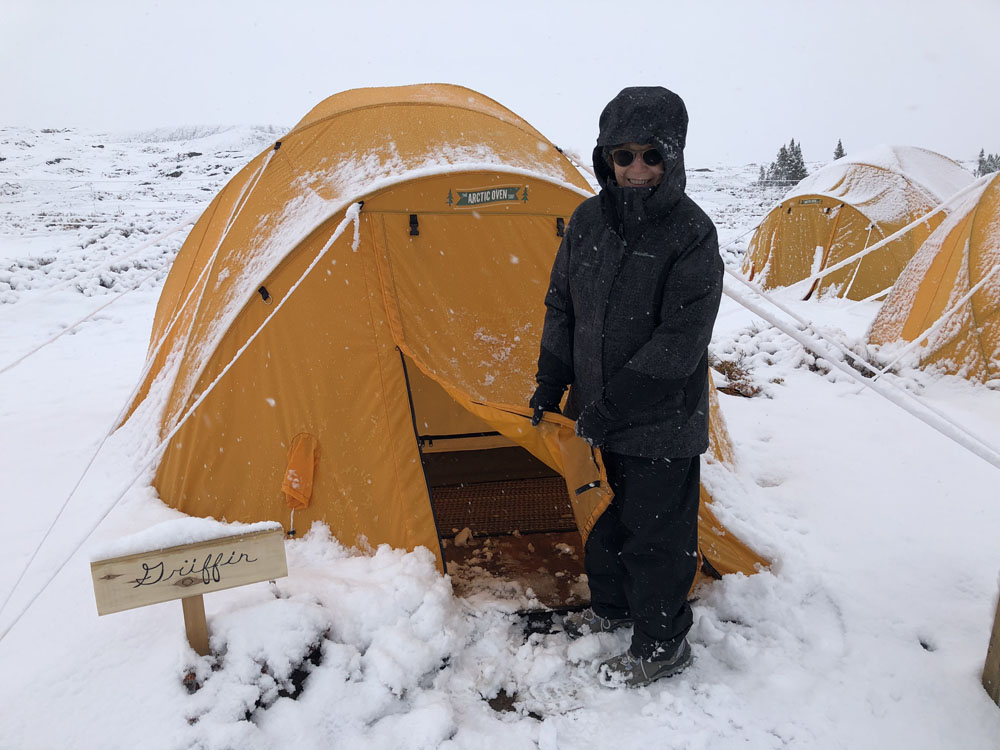 Rita Griffin in front of her tent after a surprise snowstorm on their Arctic Safari.