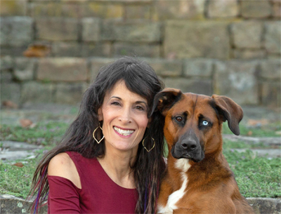 Professional pet photographer Ellen Zangla with one of her favourite subjects, a dog! Ellen Zangla Photography.