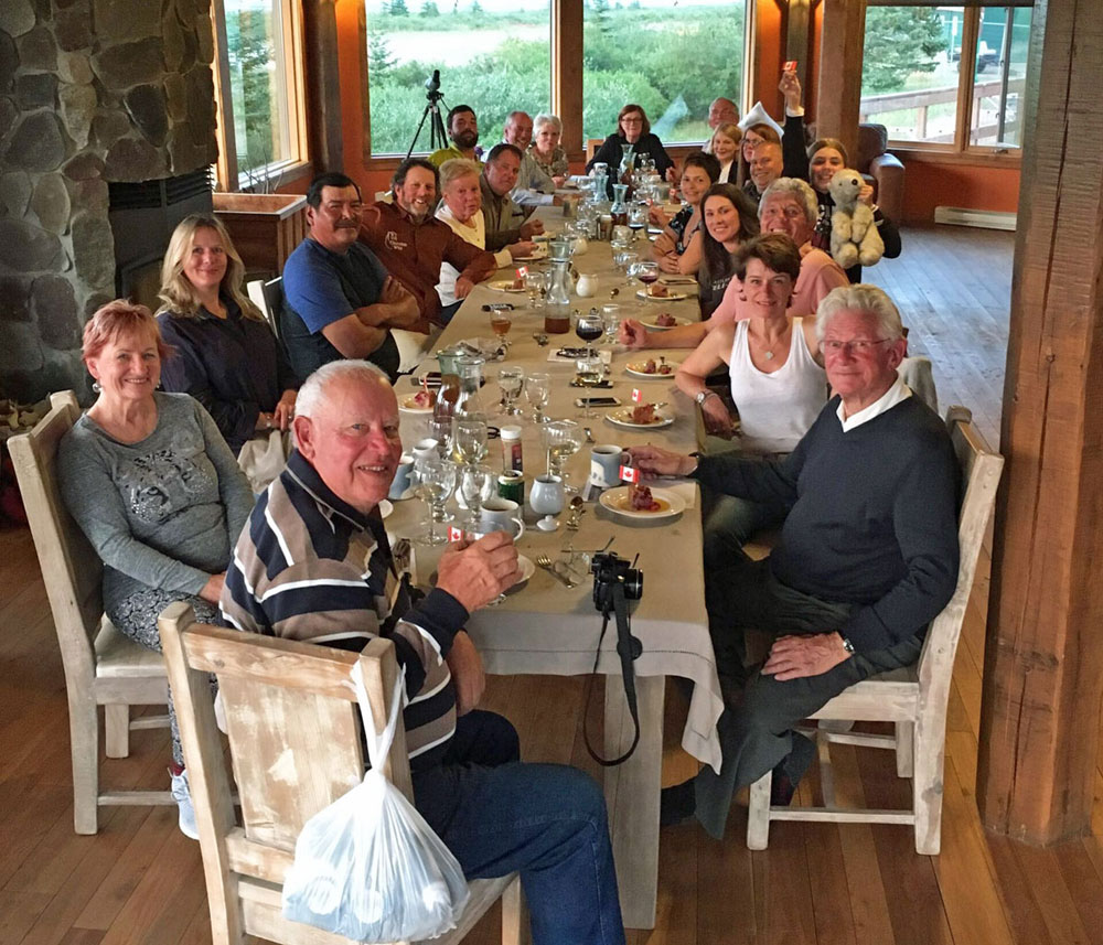 Guests and new friends from around the world bonding over a meal at Nanuk Polar Bear Lodge.