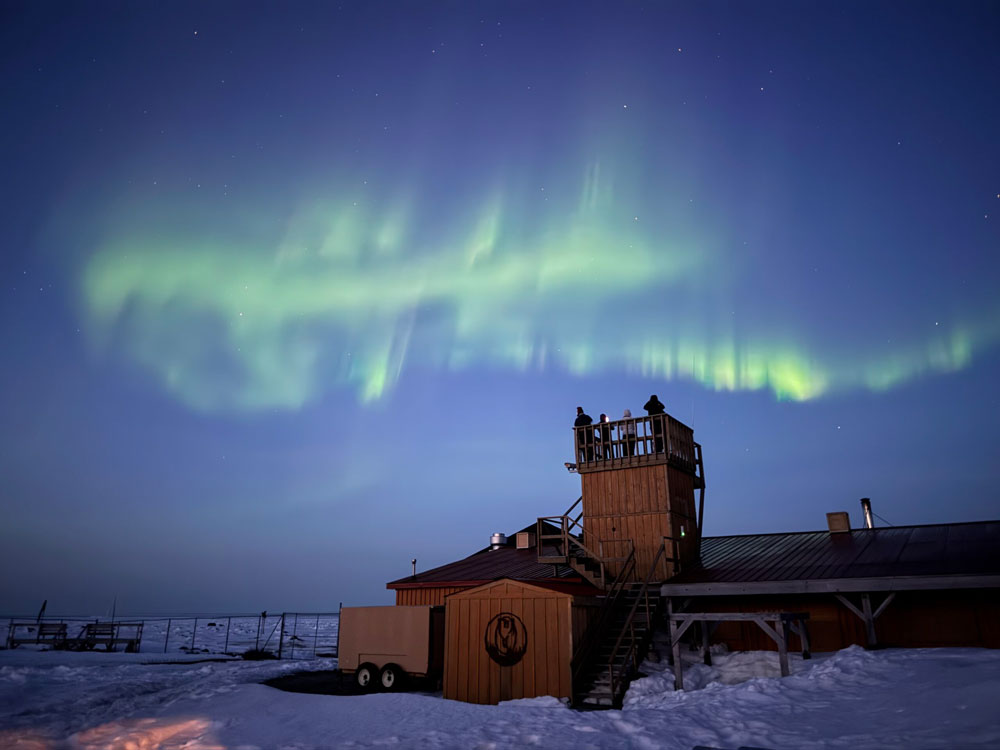Guests observing northern lights from the viewing tower at Seal River Heritage Lodge. Jackie Storry photo.