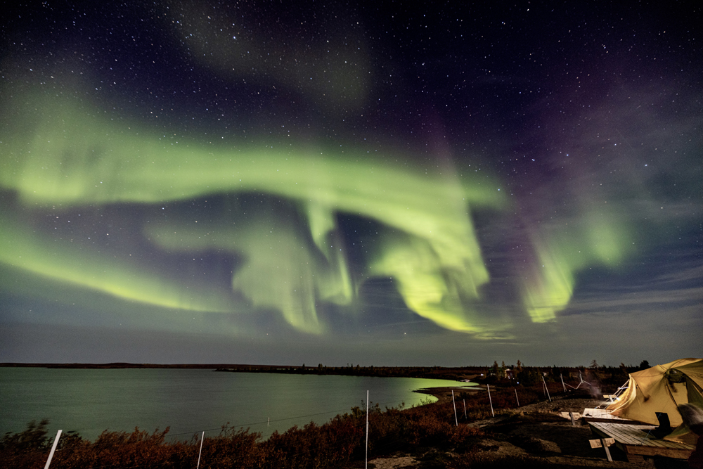 Northern lights reflecting over Schmok Lake at Tundra Camp. Eric Wichems photo.