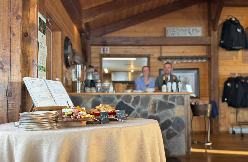Happy hour at Churchill Wild's Nanuk Polar Bear Lodge. Lodge managers Emma Dickins and Danny Nicholls smiling in the background. Cloud Wolves of the Kaska Coast safari. March 2026. Ellen Zangla photo.