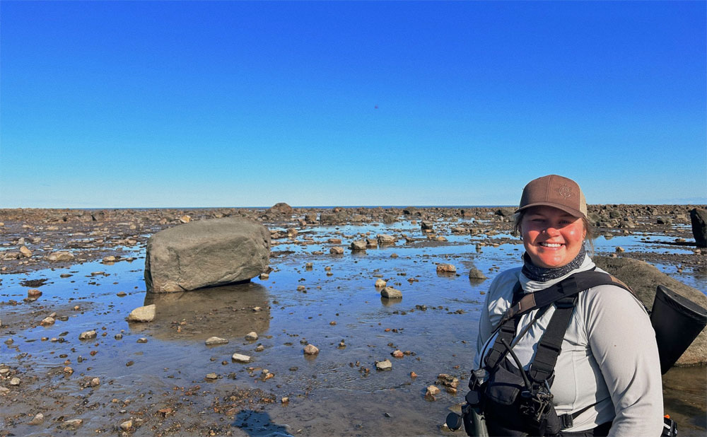 Polar bear guide Shayna Plett in the bay at low tide. Seal River Heritage Lodge.