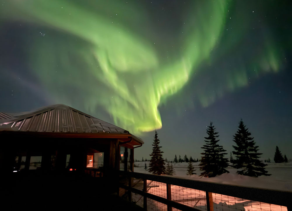 Northern lights over Churchill Wild's Nanuk Polar Bear Lodge. Cloud Wolves of the Kaska Coast safari. Ellen Zangla Photo. March 2026