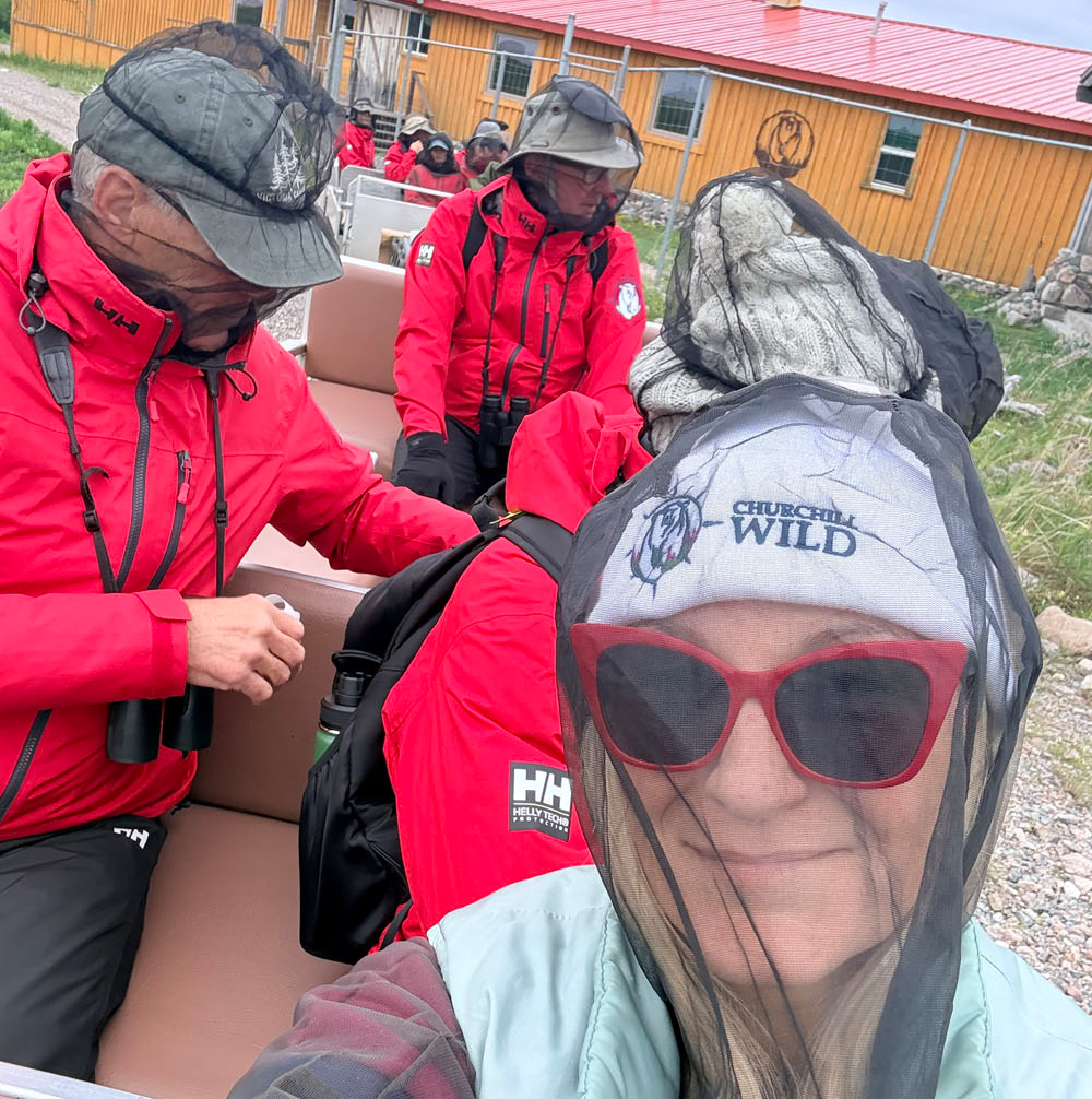 Churchill Wild diorama creator Jen Arnold in her bug jacket at Seal River Heritage Lodge. Jen Arnold photo.